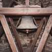 Interior.
View of bell tower showing detail of bell with wheel and timber frame support.