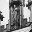 Detail of statue in niche of tower on N face.