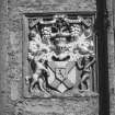Detail of heraldic panel on W front.