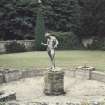 View of statue in walled garden.