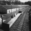 View from NW of Strathisla Halt on branch railway (Keith to Dufftown, currently not used by British Rail, but frequented by Whisky Specials in the summer), with bonded warehouses in background.
