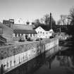 General view from SE of W side of distillery, and River Isla.
