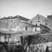 View from SW of W part of distillery, containing Engineers' Workshop.
