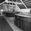Interior.
View from NW of 4 wooden washbacks in upper level of Tun Room.