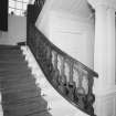 Interior. Detail of staircase showing square columns and curved balustrade