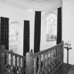 Interior. Detail of staircase at first floor level showing balustrade and coved ceiling