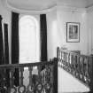 Interior. Detail of staircase at first floor level showing balustrade and coved ceiling