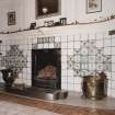 Interior. Detail of drawing room fireplace showing delft tiles, grate, fender and mantleshelf