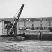 View of crane from NE showing warehouses in background.