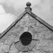 Detail of finial and circular vent.