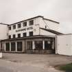 View of frontage with Bill's Bar at right from SE