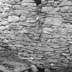 North wall of byre showing drainage channel and remains of cruck stump