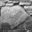 Dwelling range, east end.  Large boulder stone at base of wall.