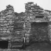 Kiln-barn, east wall showing (from left to right) fire area and flue, steps to drying area and 
grain store