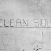 Interior view of gas decontamination building showing painted sign on wall inscribed 'Clean Side'.