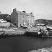 General view of harbour and warehouse from south west