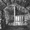 Photograph showing interior of cart shed, cruck-frame and roof groundwork formed of salvaged ships' timber; Laidhay, Caithness.