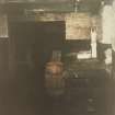 Interior.
Photographic copy of colour polaroid showing view of curing house with kiln door in background.