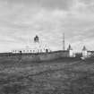 Distant general view from SW of lighthouse showing compound wall and gates
