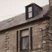 Detail of first floor windows and dormer.