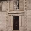 Detail of front entrance and first floor window.