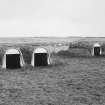 View from NW of two pairs of torpedo store huts.