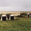 View from NW of two pairs of torpedo store huts.