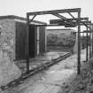 View from W looking along bomb store sheds and bomb loading gantry.