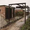 View from W looking along bomb store sheds and bomb loading gantry.