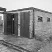 View from SE of a single bomb store shed showing doors and part of the loading gantry.