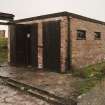 View from SE of a single bomb store shed showing doors and part of the loading gantry.