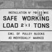 Interior view of bomb store shed showing detail of crane weight restriction notice.