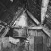 Building A, general  view of kitchen hearth, chimney canopy, and coupled rafters
