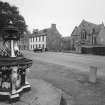 Ardesier Parish Church and 57 and 58 High Street. General view from NE showing late 19th century cast iron fountain