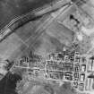 RAF WWII vertical aerial photograph of Dalcross Airfield.  Visible are the main hangars and the technical area to the NW.