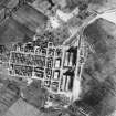 RAF WWII vertical aerial photograph of Dalcross Airfield.  Visible are the main hangars, part of the main runway and  the technical area to the NW.
