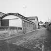 General view from south showing cattle courts and stable on left and cattle shed on right