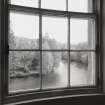 Interior. 1st floor, N bedroom, view of river through curved E window of bay