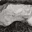 Fragment of shaped stone at foot of Early Christian cross.