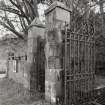 Main NW entrance, gate piers, wrought-iron gates and battlemented boundary wall, detail