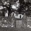 General view from E showing entrance gate and church beyond