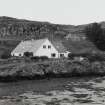 Muck, Port Mor. Port Mor House Hotel and building (NM 4208 7938) on terrace above. View from SE.