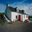 Muck, Port Mor, Pier Cottage. Cottage and gear store. View from NNW.