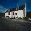 Muck, Port Mor, Pier Cottage. Cottage and gear store. View from SSW.