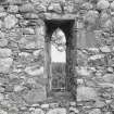 Interior. S wall, view of arched window from N