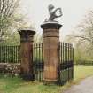 View of inner gate pier (surmounted by heraldic beast) and plain outer pier