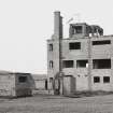 Fearn Airfield Naval Control Tower. View from NE showing remains of Nissen hut and toilet block to rear.