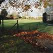 Detail of gate adjacent West wing of Geanies House with view of West garden beyond