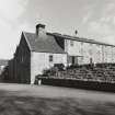 View from WSW of former maltings block (right), kiln (centre), and NW side of distillery (left)