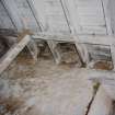 Detail of upper floor above byre stall showing openings in floor to vent ducts to roof space above granary